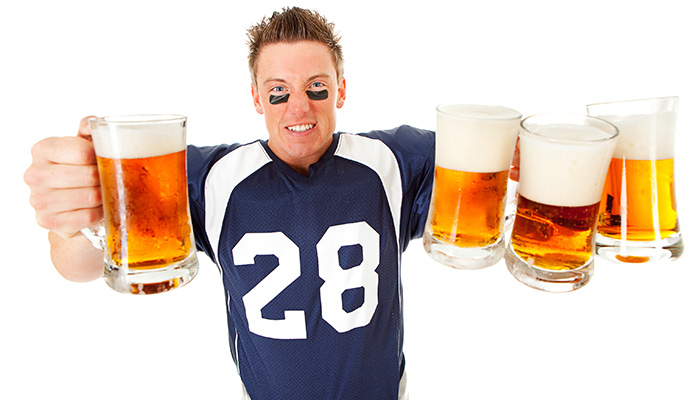 ​A quarterback holding beer