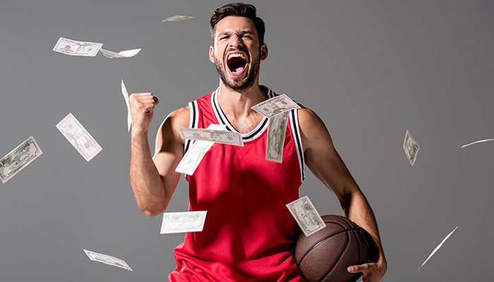Basketball player with money around him
