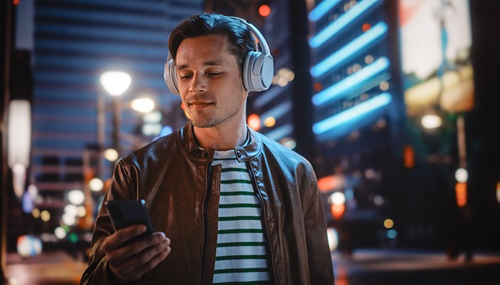 Person with Headphones Listening to Podcast