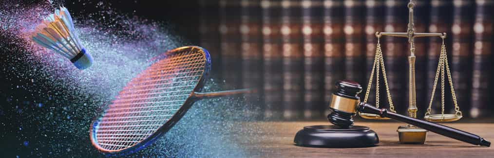 Badminton racket and shuttlecock, law book, and judges gavel and block
