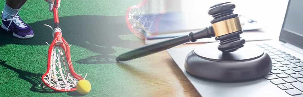 Lacrosse stick and ball, judges gavel and block, and laptop