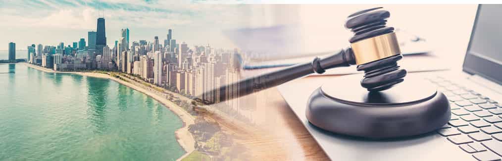 The Chicago skyline behind a judge's gavel, which rests on a laptop computer.