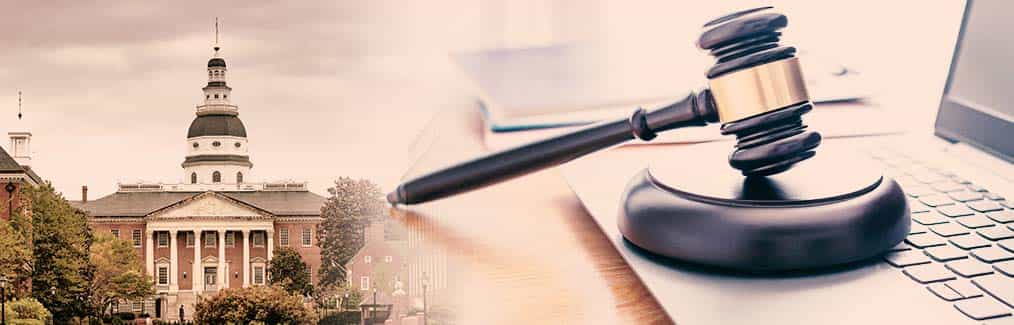 photograph of the skyline of the city of Annapolis, a laptop, judge's gavel and block