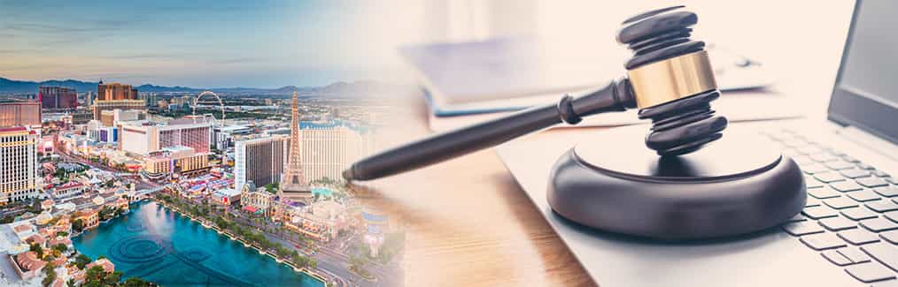 The Las Vegas skyline behind a judge's gavel, which rests on a laptop computer.