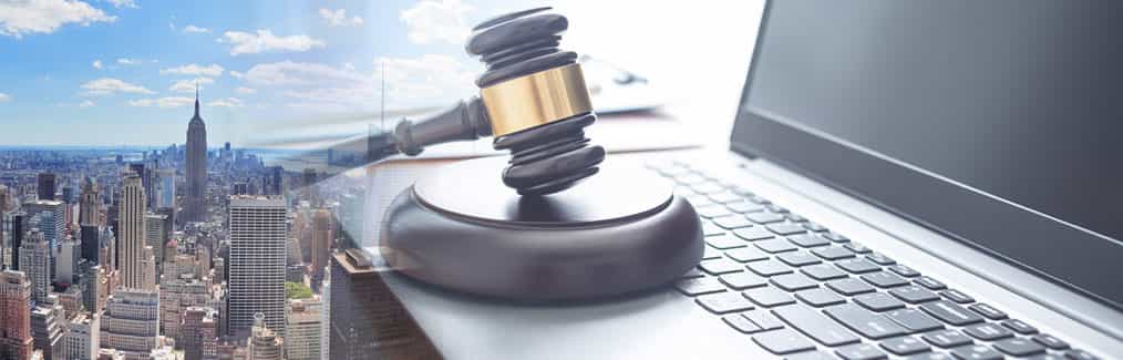 Cityscape of New York, Judges gavel and block with laptop placed on a desk