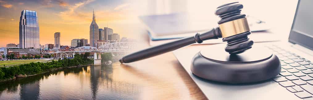 The Nashville skyline and a judge's gavel resting on top of a laptop computer.