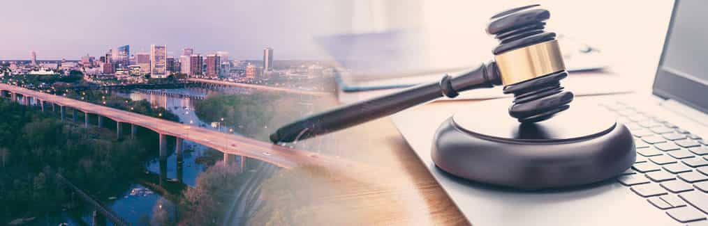 The Richmond skyline and a judge's gavel resting on top of a laptop computer.
