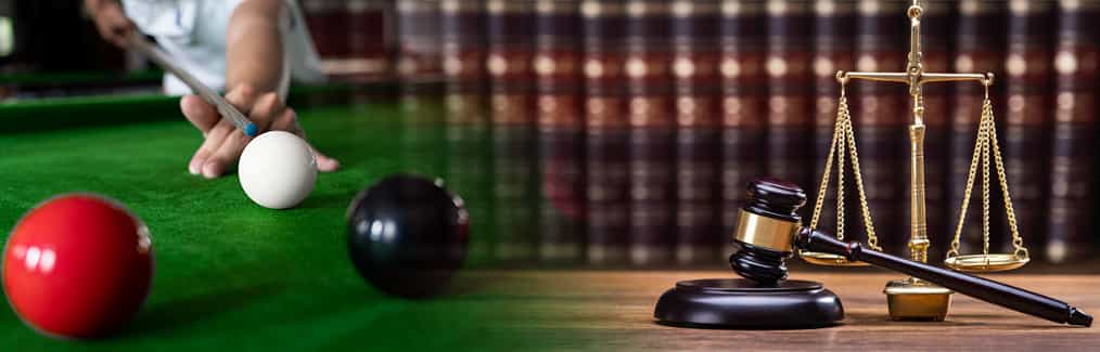Snooker player and table, law books on shelf, and statue of Scales of Justice