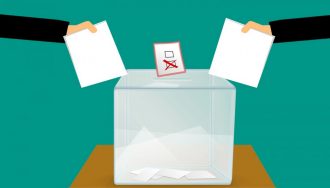 Voters Placing Votes into Ballot Box