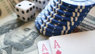 Dice Casino Chips and Cards over US Dollar Bills