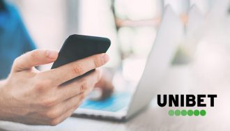 Unibet Logo Next to a User with Phone and Laptop