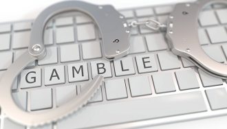 The Word Gamble on a Keyboard with Handcuffs on It