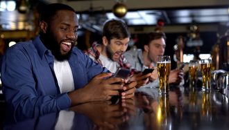 Excited Sports Betting Players at a Sports Bar in Detroit