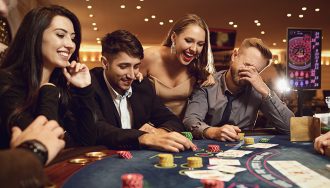 Excited Gamblers on a Casino Table Filled with Cards and Chips