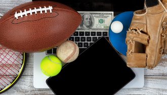 Sports Gear and Cash over a Laptop and a Tablet