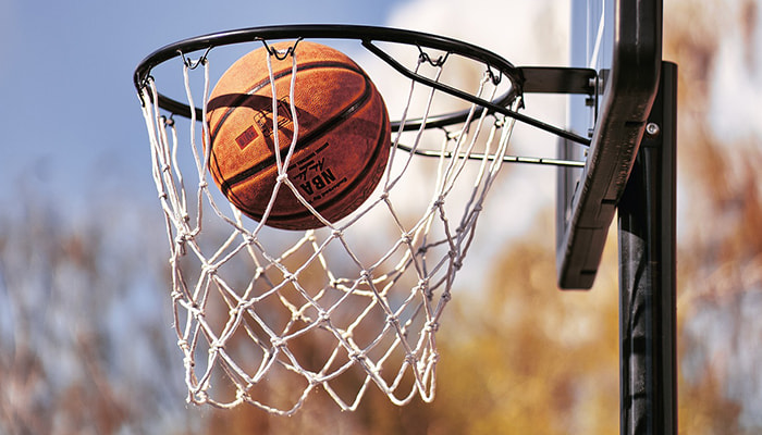 A basketball falling into the net