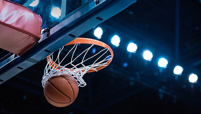 A ball under a basketball ring on a court