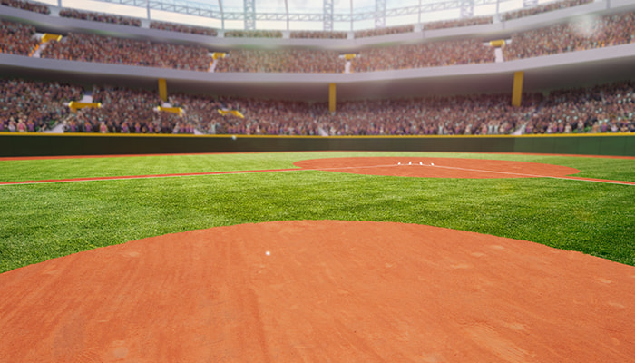 A picture of a baseball inside the batter’s box on a field.