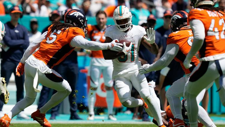 Dolphin player rushing through defenders.