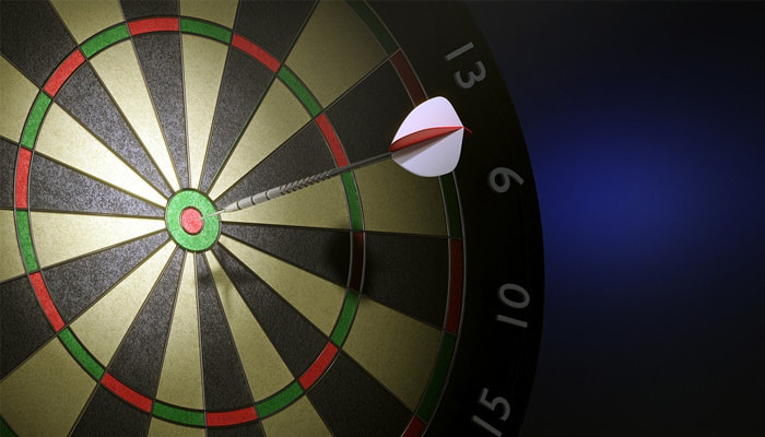 A dartboard with a dart in the bullseye