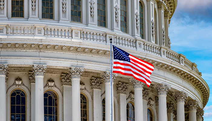 The American flag waiving outside of the Capitol Building