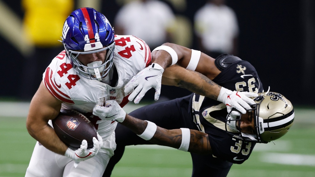 New York Giants running back Cam Skattebo (44) runs against New Orleans Saints safety Jonas Sanker (33) during the first half of an NFL football game, Sunday, Oct. 5, 2025, in New Orleans. (AP Photo/Butch Dill)